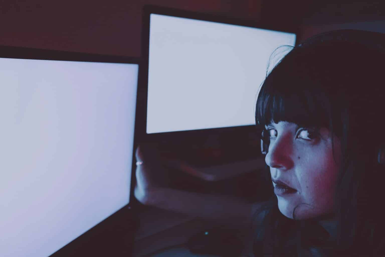 Young streamer woman working at night from home