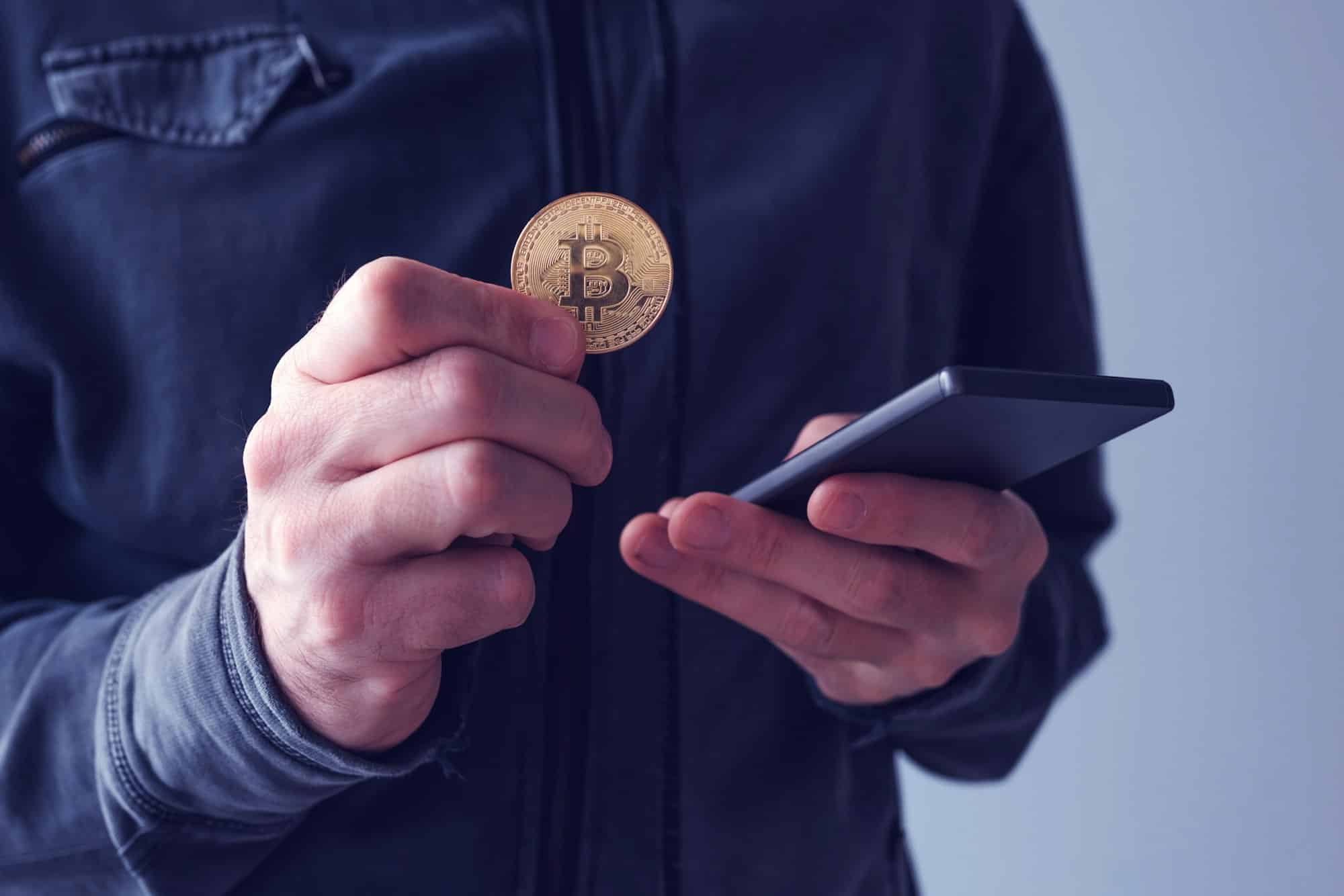 Man with bitcoin and mobile phone