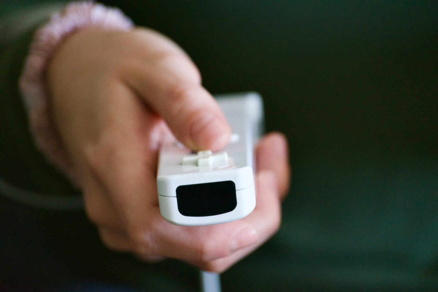 Wii Sports Club : Votre Nouvelle Aventure Ludique pour des Soirées Mémorables sur Wii U A woman using a video game controller to relax and destress at home while staying indoors, inside