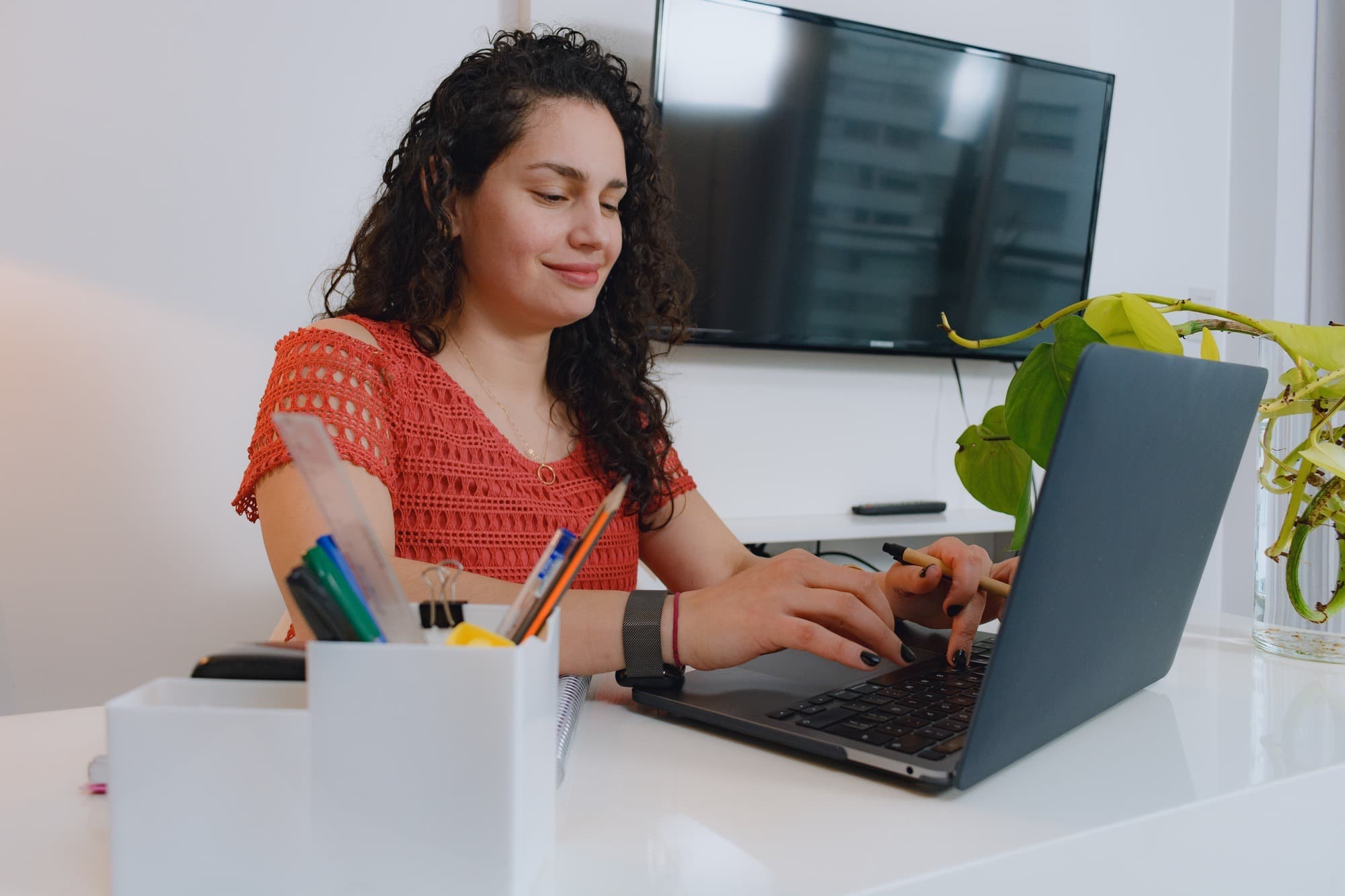 Female editor at home with laptop concentrating on what to write in a script.