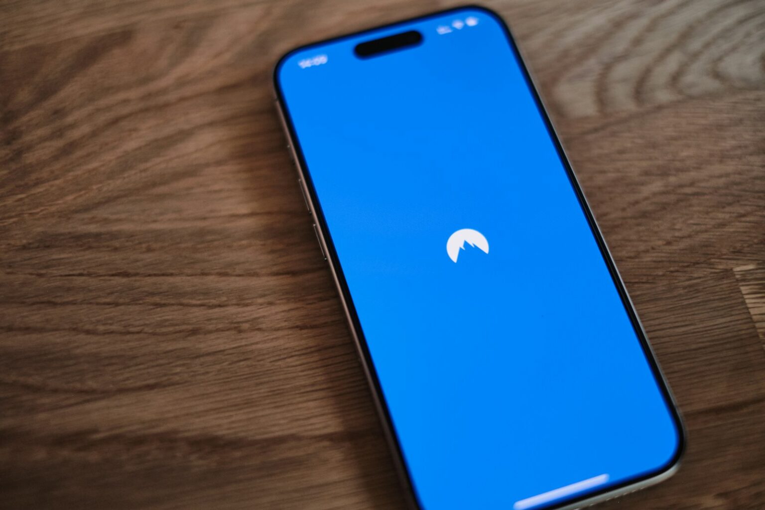 A blue phone sitting on top of a wooden table