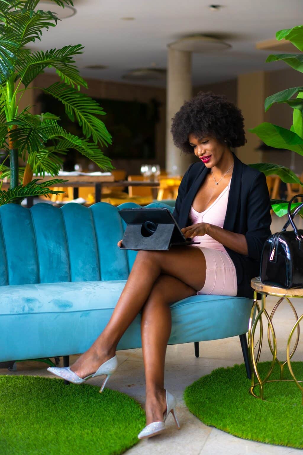 Young entrepreneur of black race and afro hair making a video call of a work meeting