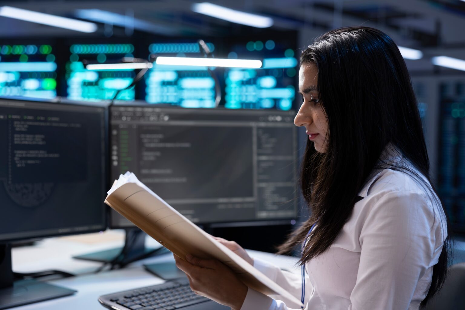 IT supervisor verifying data center infrastructure documentation paperwork