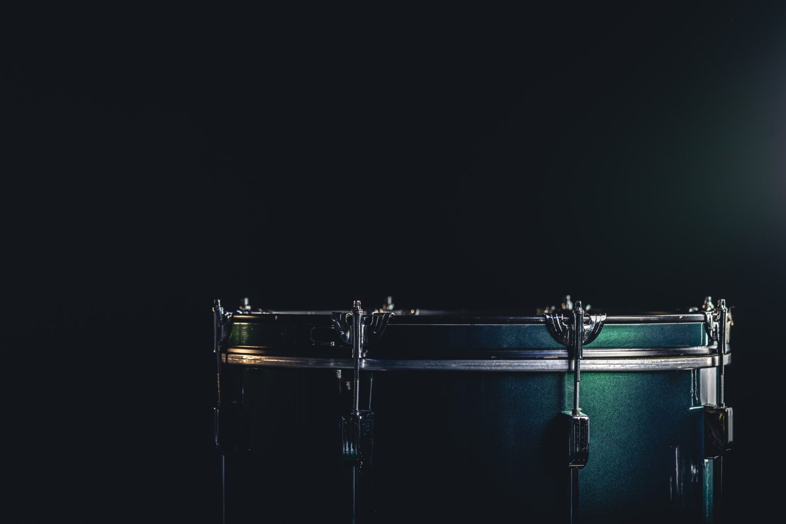 The floor tom on under studio lighting, copy space, music concept.