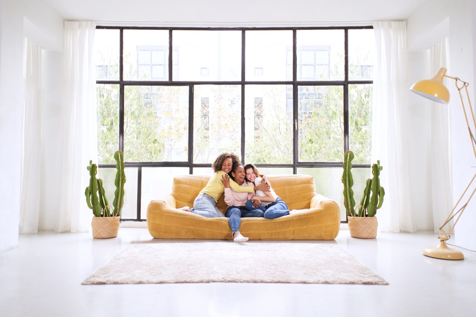Group of young female multiracial young friends play video games together at home.