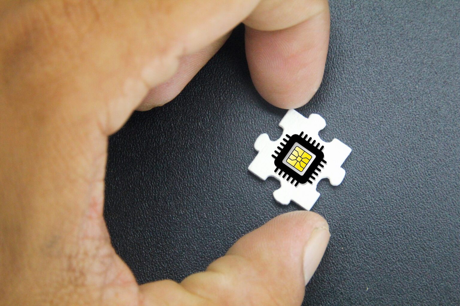hand holding puzzle with microchip icon.