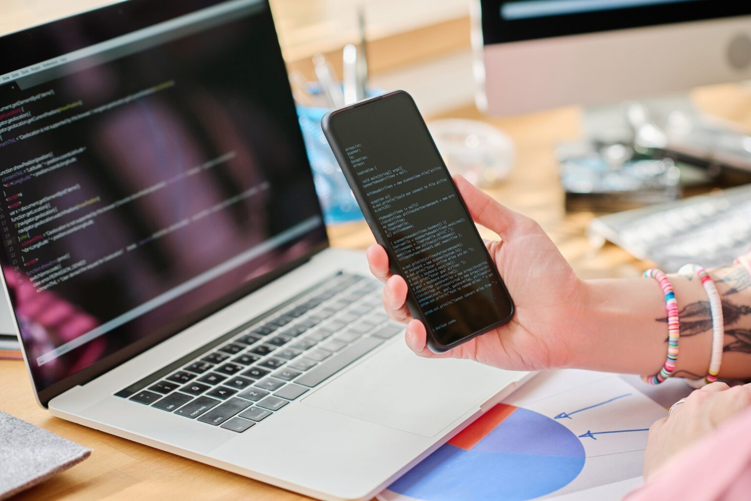 Programmer connecting smartphone with laptop